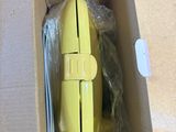 a yellow computer mouse in a box on a table