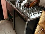 a kitchen with a sink and a dishwasher in it