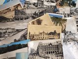 a pile of old postcards sitting on top of a table