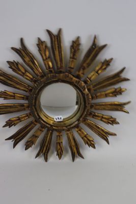 a gold sunburst on a white surface