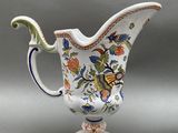 a white pitcher with a floral design on it