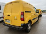 a yellow van parked in a parking lot next to other vans