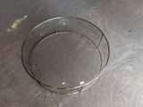an image of a glass bowl on a metal surface