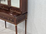 a small desk with a mirror on top of it
