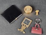 a keychain, wallet, key chain, and other items that are on a table