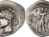 a silver coin with a woman and a man on it