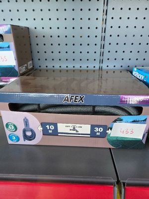 a box with a hose sitting on a shelf in a store