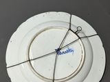 a white plate with a wire around it on a table