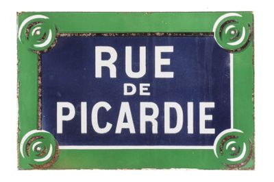 blue and white street sign with white lettering on green background