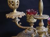 a three - tiered candle holder with candles on top of it