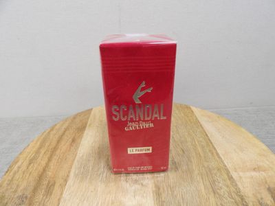 a red box on a wooden table with a white wall in the background