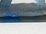 a blue and black sculpture of a polar bear on a rock