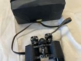 an image of a pair of binoculars sitting on top of a bed