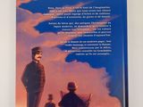 the back cover of a book with a picture of a man and two children standing on a hill
