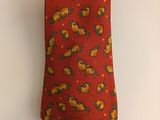 an orange neck tie with a yellow bird design on it