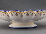 a white bowl with blue and yellow designs on it
