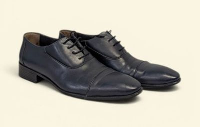 a close up of a pair of black shoes on a white background