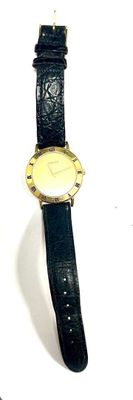 GUCCI, montre de dame en métal doré bracelet cuir