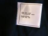 a close up of a label on the back of a black jacket