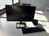 a desk with a computer monitor and keyboard on it