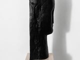 statue of a woman ' s head on a black pedestal