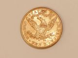 a close up of a gold coin with an eagle on it