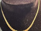 a gold necklace on a mannequin mannequin mannequin mannequin mannequin mannequin mannequin mannequin mannequin