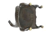 a metal object that is sitting on a white surface