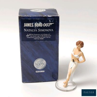 a figurine of a woman in a bathing suit next to a box of james bond 007
