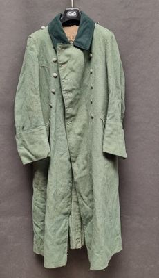 an image of a green coat hanging on a wall