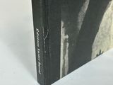 the book is sitting on a white surface with a black and white photo