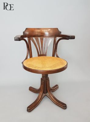an image of a wooden chair with a wicker seat on a white background