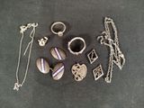 a lot of jewelry that is laying out on the table