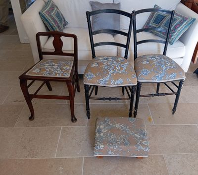 four chairs that are sitting in front of a couch