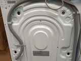 an image of a white dishwasher sitting on top of a wooden pallet