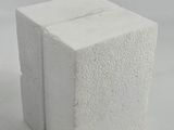 a white block of cement sitting on a white surface