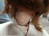 a close up of a doll ' s neck with a tag on it