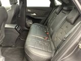 the back seats of a car with a tablet on the floor