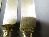 two knives that are sitting next to each other on a table