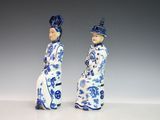 pair of blue and white porcelain figurines of a man and a woman