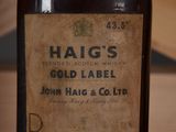 a bottle of haig ' s gold label sitting on a table