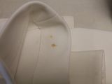 a close up of a white shirt with a yellow spot on it
