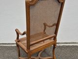 a wooden chair that is sitting on the pavement