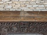 an old wooden chest with carvings on the top of it