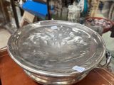 a metal bowl sitting on top of a wooden table