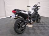a white and black motorcycle parked in a garage
