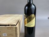 a bottle of wine sitting next to a wooden box