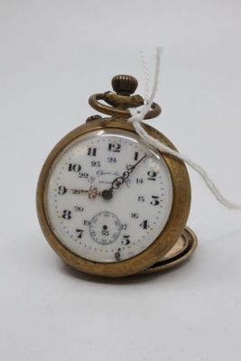 a small gold pocket watch with a chain around it