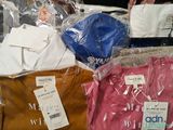 a lot of t - shirts that are wrapped in plastic