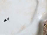 a close up of a plate with a bird on it